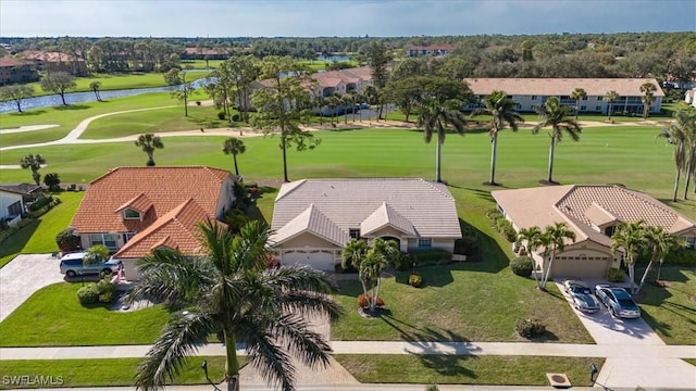 drone / aerial view featuring view of golf course and a water view