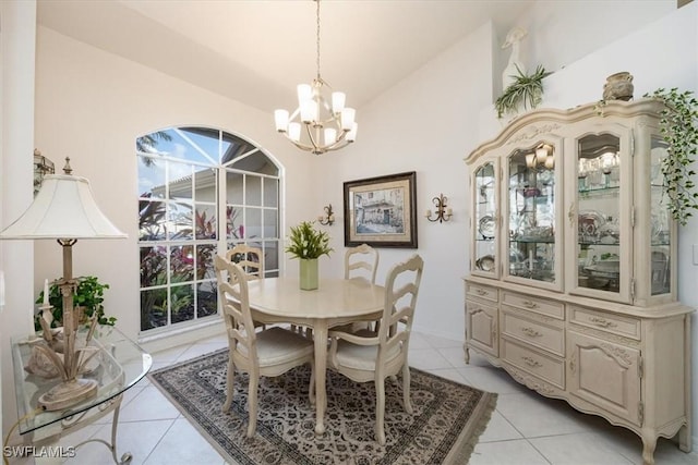 dining space with light tile patterned floors, vaulted ceiling, and an inviting chandelier