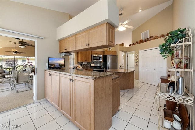 kitchen featuring high vaulted ceiling, a peninsula, visible vents, appliances with stainless steel finishes, and dark stone countertops