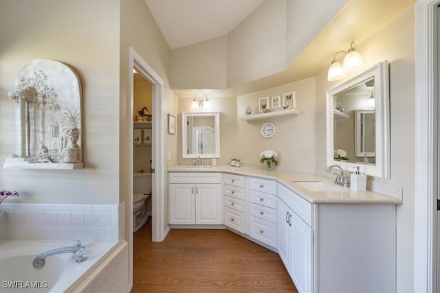 full bathroom featuring a sink, toilet, and double vanity