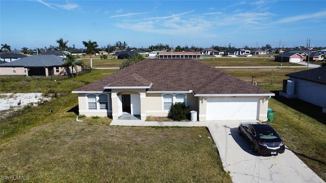 single story home featuring a garage and a front lawn