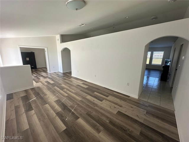 unfurnished living room with dark hardwood / wood-style floors