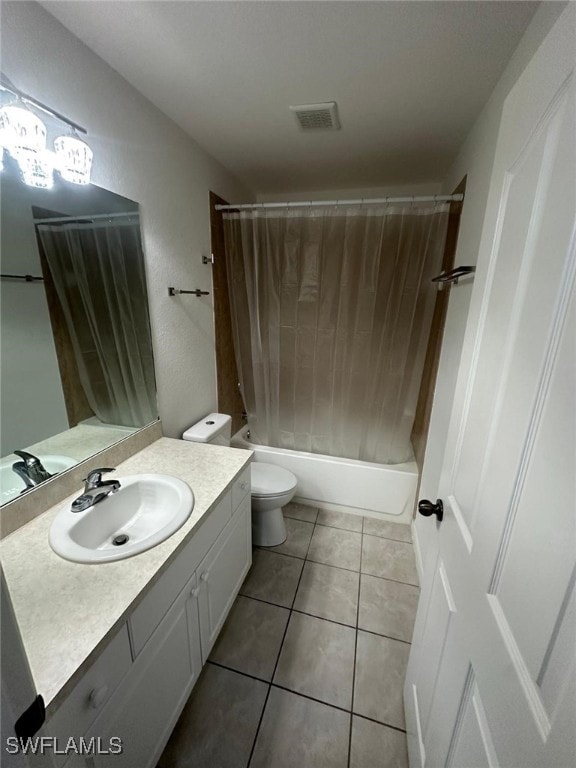 full bathroom featuring vanity, toilet, tile patterned flooring, and shower / bath combo