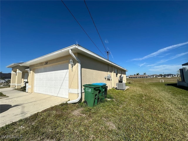 view of home's exterior featuring cooling unit, a garage, and a lawn