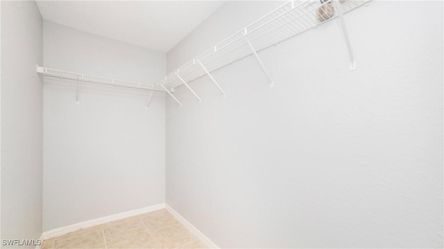 spacious closet with light tile patterned flooring