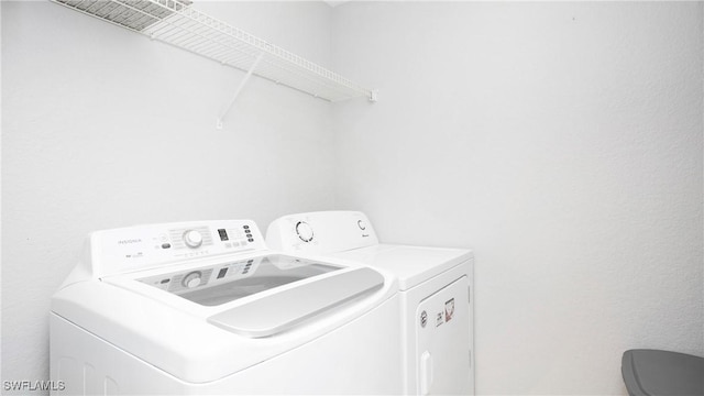 clothes washing area featuring washer and dryer