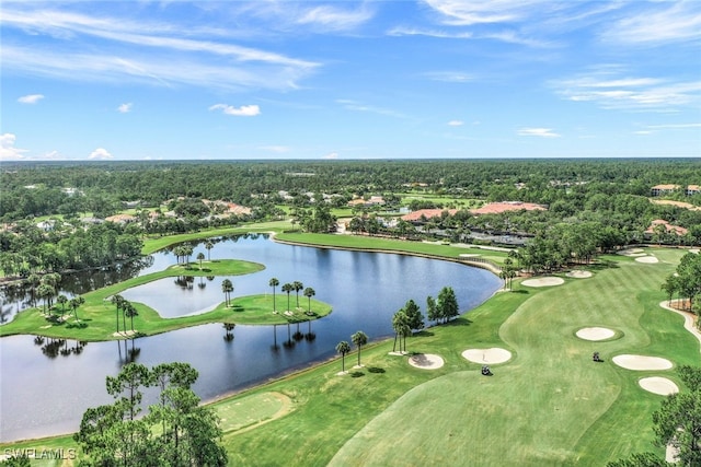 birds eye view of property with golf course view and a water view