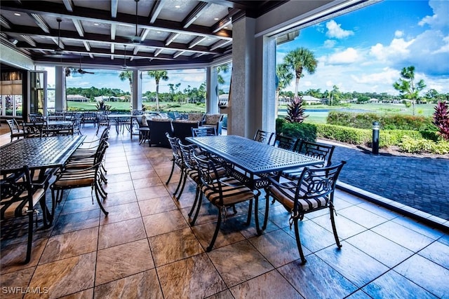exterior space featuring a healthy amount of sunlight, beam ceiling, and coffered ceiling