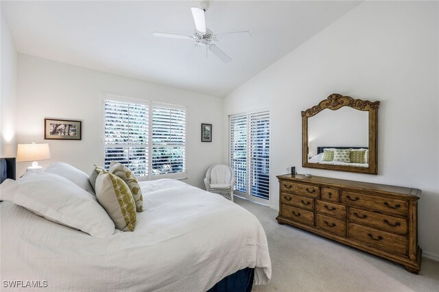 bedroom with ceiling fan, light colored carpet, and vaulted ceiling