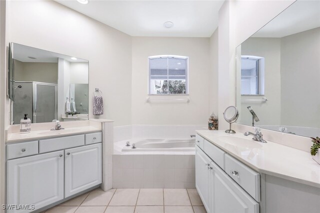 bathroom featuring independent shower and bath, vanity, and tile patterned floors