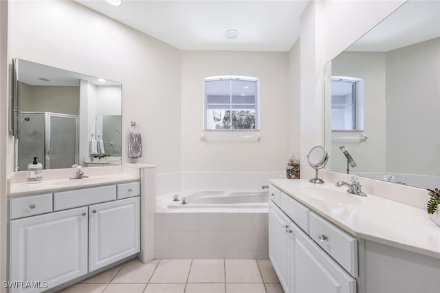 bathroom featuring a bath, a stall shower, a sink, and tile patterned floors