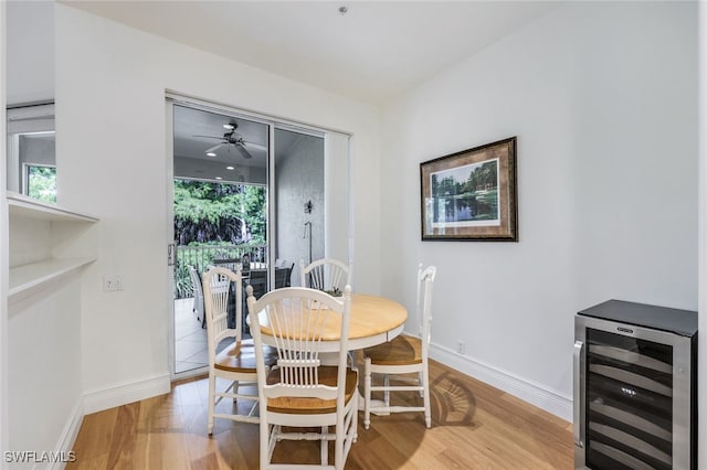 dining room featuring wine cooler and light hardwood / wood-style flooring