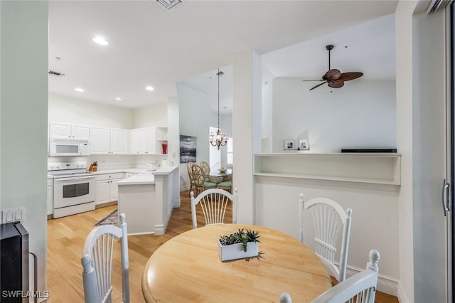 dining area featuring ceiling fan with notable chandelier and light wood-type flooring