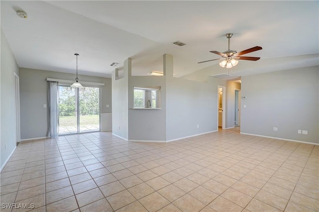 spare room featuring lofted ceiling, light tile patterned floors, and ceiling fan