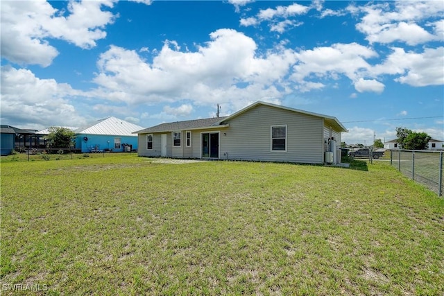 rear view of house featuring a yard