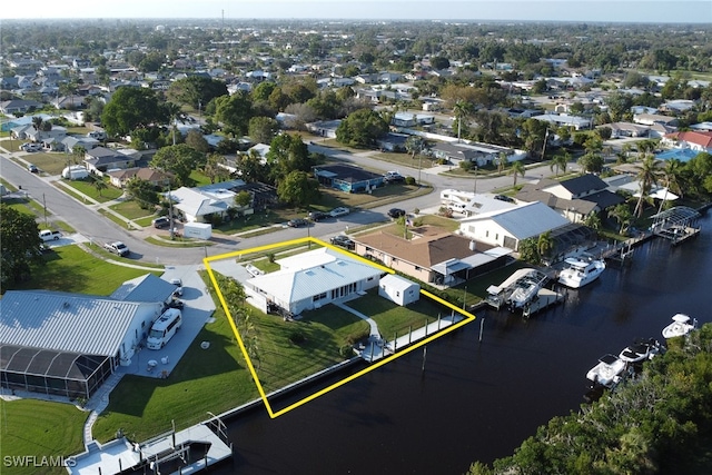 drone / aerial view featuring a water view and a residential view