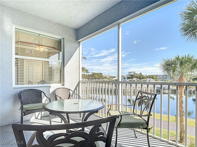 sunroom / solarium featuring a water view