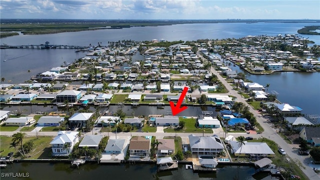 bird's eye view featuring a water view and a residential view