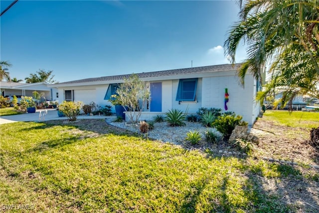 ranch-style house with an attached garage and a front lawn