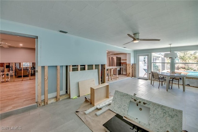 living room with ceiling fan and ornamental molding