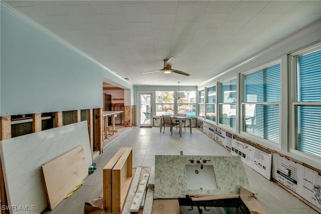 unfurnished sunroom with a ceiling fan