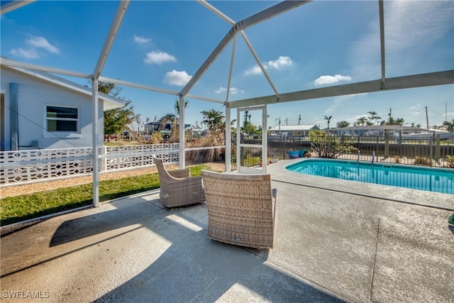 view of swimming pool with a patio and glass enclosure