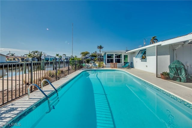 view of swimming pool with a fenced in pool, fence, and a patio