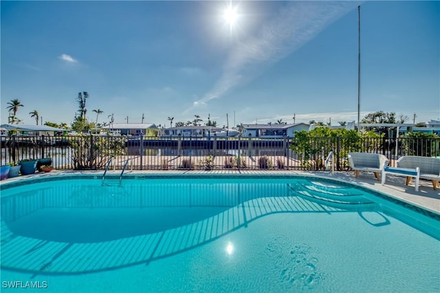 view of pool with a water view