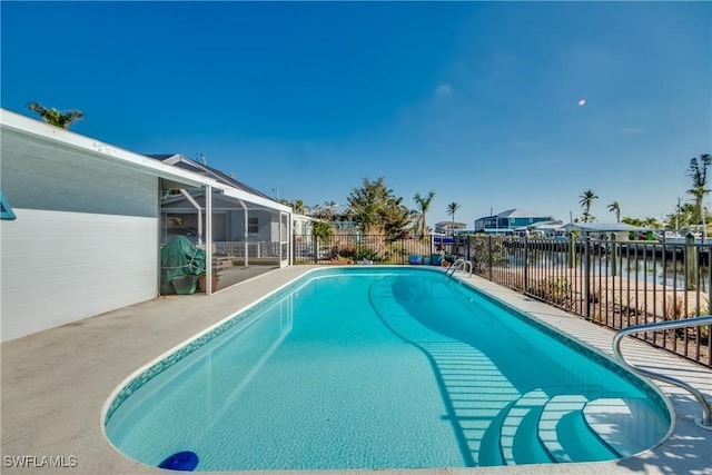 view of swimming pool with a fenced in pool, fence, and a patio