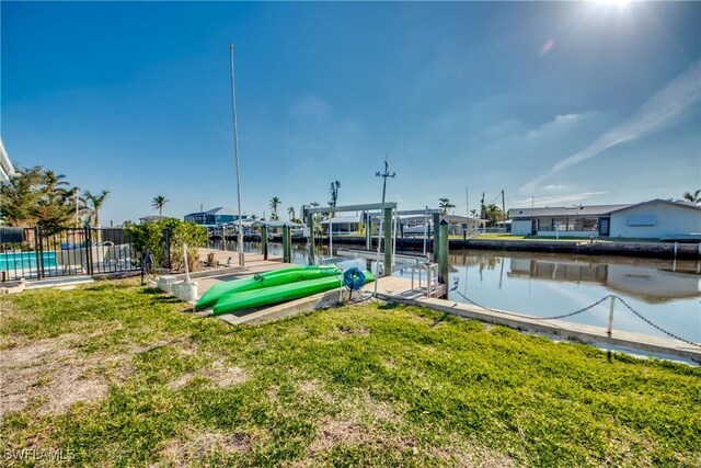 dock area featuring a water view and a yard