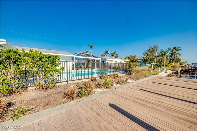 view of swimming pool featuring a lanai, fence, and a fenced in pool