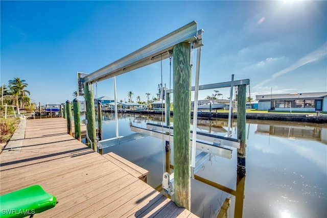 view of dock featuring a water view and boat lift