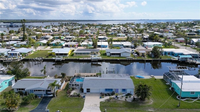 drone / aerial view featuring a water view and a residential view