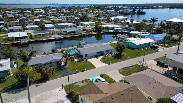 bird's eye view featuring a water view and a residential view