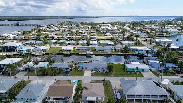 birds eye view of property with a water view and a residential view