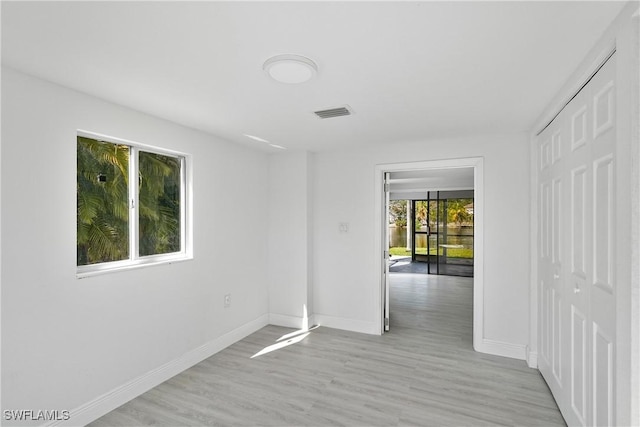 spare room featuring light hardwood / wood-style flooring