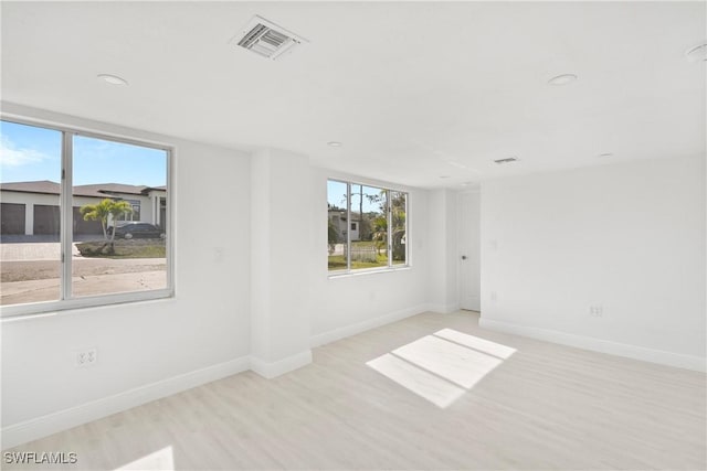 unfurnished room with light wood-type flooring