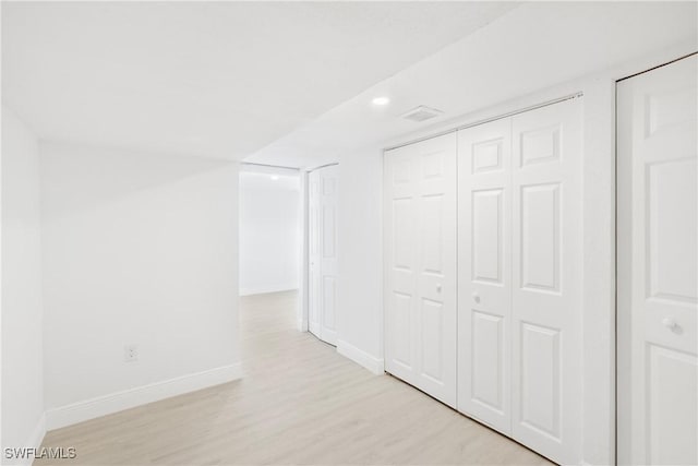 hallway with light hardwood / wood-style flooring