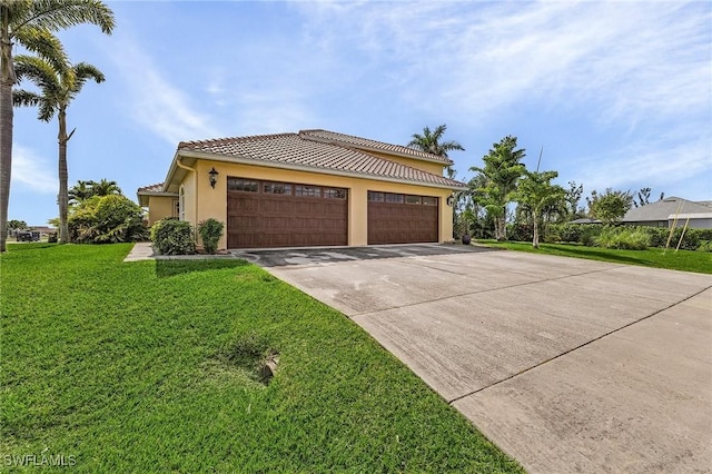 view of front of property featuring a garage and a front lawn