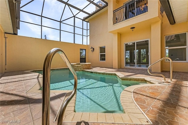 view of swimming pool with a lanai and a patio