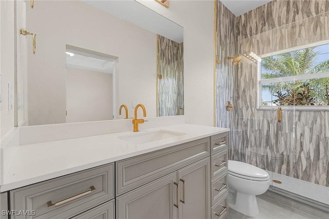 bathroom featuring vanity, toilet, a shower with shower door, and tile patterned flooring