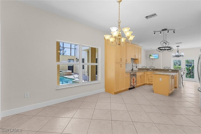 kitchen featuring decorative light fixtures, a notable chandelier, light brown cabinetry, and kitchen peninsula