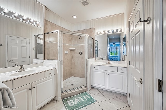 bathroom featuring tile patterned flooring, vanity, and a shower with door