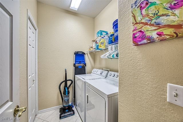 washroom featuring light tile patterned floors and washer and dryer