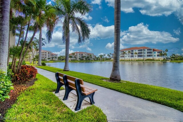 view of community featuring a yard and a water view