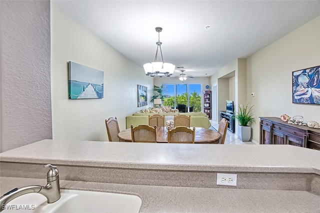 dining room with sink and a notable chandelier