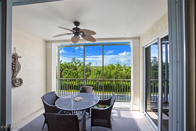 sunroom / solarium featuring ceiling fan