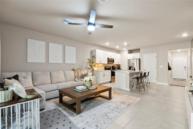 tiled living room featuring ceiling fan