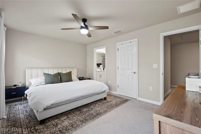 carpeted bedroom with ceiling fan and ensuite bathroom