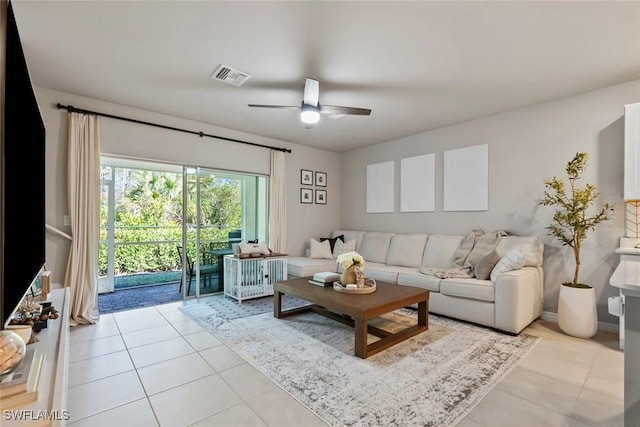 living room with ceiling fan and light tile patterned floors